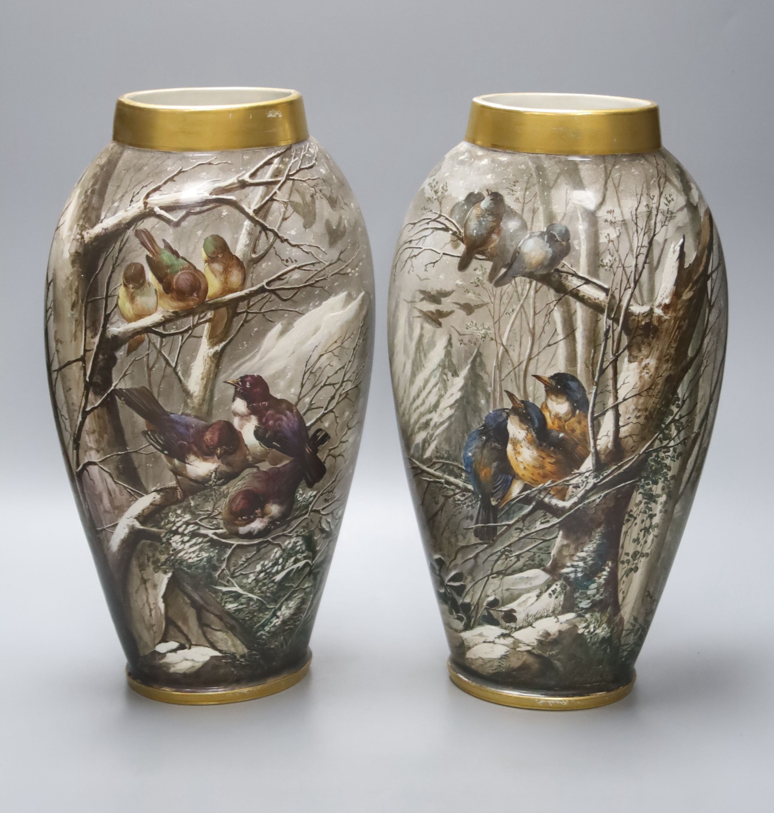 A pair of late 19th century French St Denis painted vases, decorated with birds in a landscape, signed by the artist, height 35cm